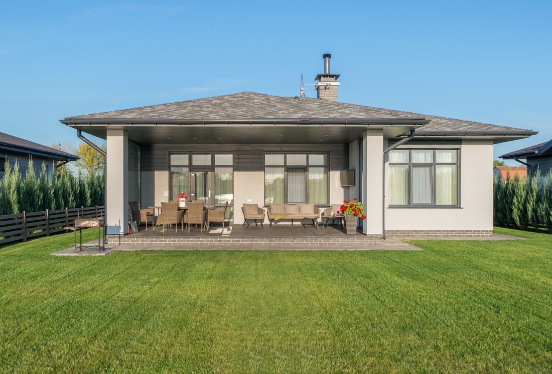 A neat suburban home garden with a lawn and patio