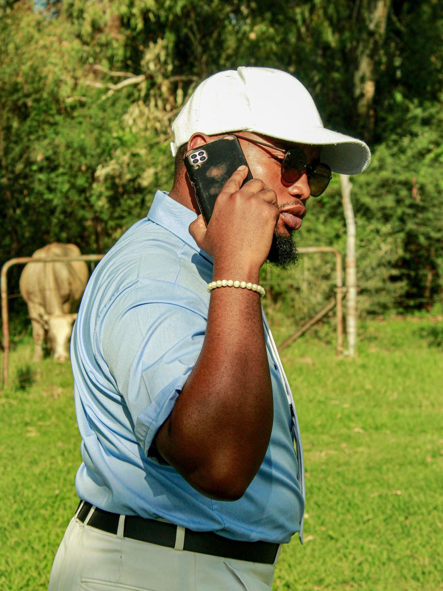 A man in a cap talking on his phone outdoors